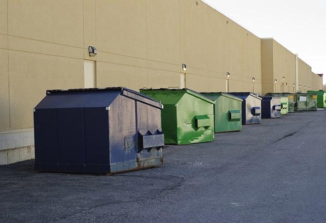 a row of industrial dumpsters for construction waste in Blakely